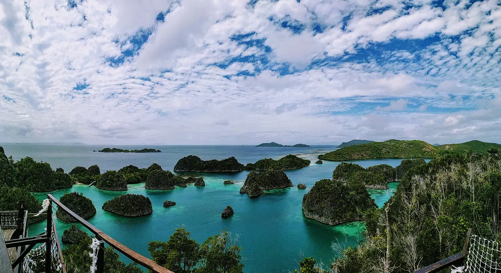 Piaynemo islets under a wide cloudy sky, seen from the viewpoint