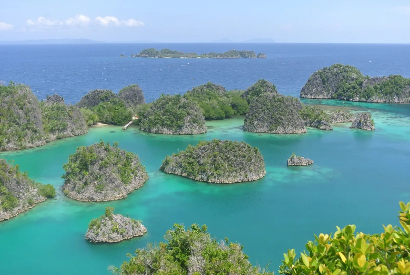 Green limestone islands scattered across pale turquoise shallows
