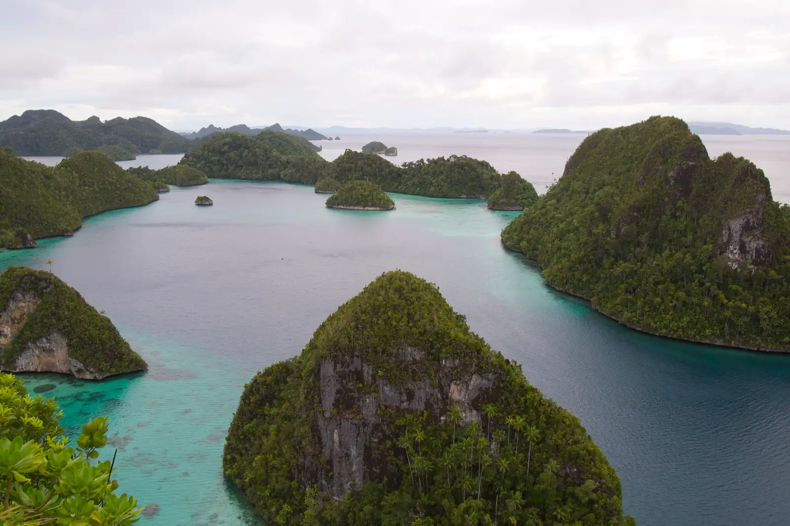 Wayag's steep karst cones rising from a turquoise lagoon
